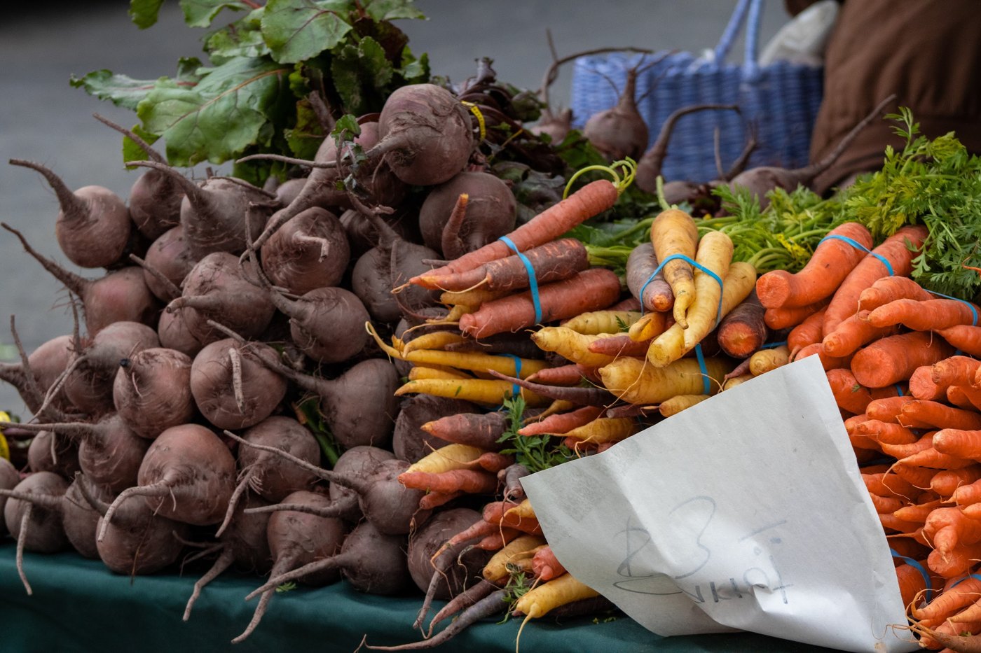 Beetroot and rainbow carrots piled on a market stall